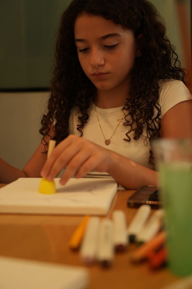A young guest working on a canvas